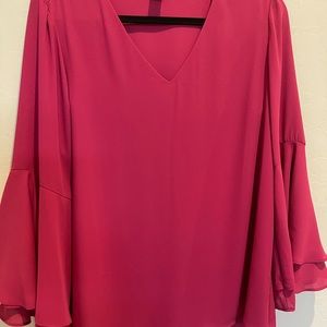 Sleek and simple with elegant bell sleeves size L in a berry color